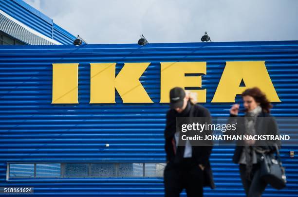 People walk outside Europe's biggest Ikea store is pictured in Kungens Kurva, south-west of Stockholm on March 30, 2016. - Ikea founder Ingvar...