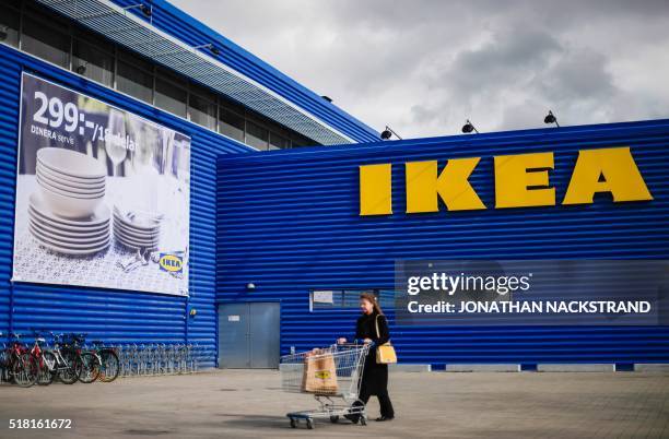 Client walks outside Europe's biggest Ikea store is pictured in Kungens Kurva, south-west of Stockholm on March 30, 2016. - Ikea founder Ingvar...