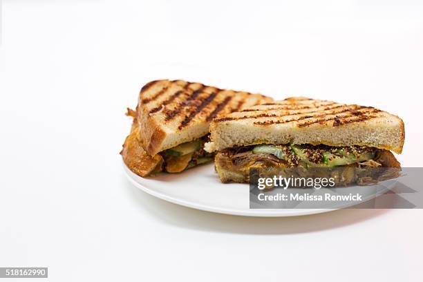 Grilled cheese on white bread with cheddar cheese, cucumber pickles, grainy mustard and pulled pork shoulder is pictured.