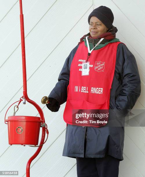 Salvation Army bell ringer, Delores Wright, works in front of a Kmart store December 2, 2004 in Chicago, Illinois. Wright has worked as a bell ringer...