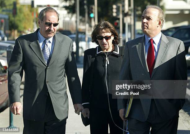 Defense attorneys Mark Geragos and Pat Harris escort Jackie Peterson, convicted murderer Scott Peterson's mother, back from a lunch break to the...