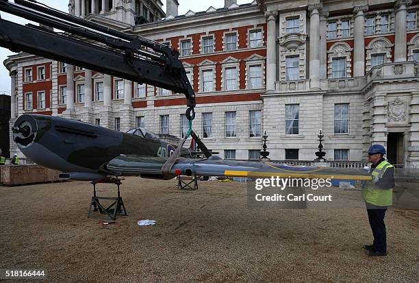 The wing of a World War 2 Spitfire Mk XVI is fitted onto the body of the plane as it assembled at Horse Guards Parade on March 30, 2016 in London,...
