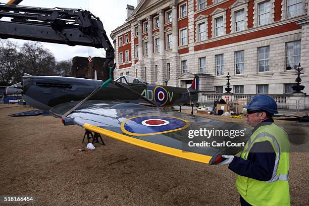 The wing of a World War 2 Spitfire Mk XVI is fitted onto the body of the plane as it assembled at Horse Guards Parade on March 30, 2016 in London,...