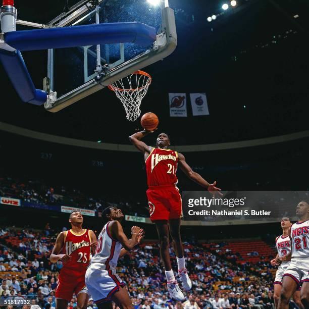 Dominique Wilkins of the Atlanta Hawks goes for a dunk against the New Jersey Nets during the NBA game circa 1993 in East Rutherford , New Jersey....