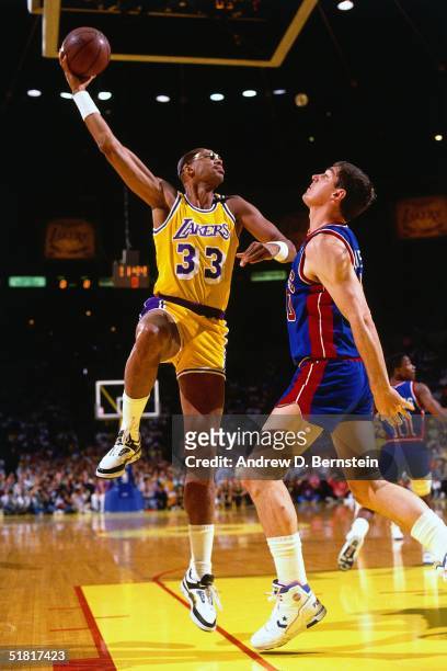 Kareem Abdul-Jabbar of the Los Angeles Lakers goes up for a sky hook against the Bill Laimbeer of the Detroit Pistons during Game Three of the 1989...
