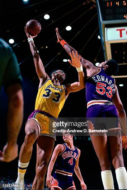 Kareem Abdul Jabbar of the Los Angeles Lakers goes up for a sky hook against the James Edwards of the Phoenix Suns during an NBA game cira 1983 at...