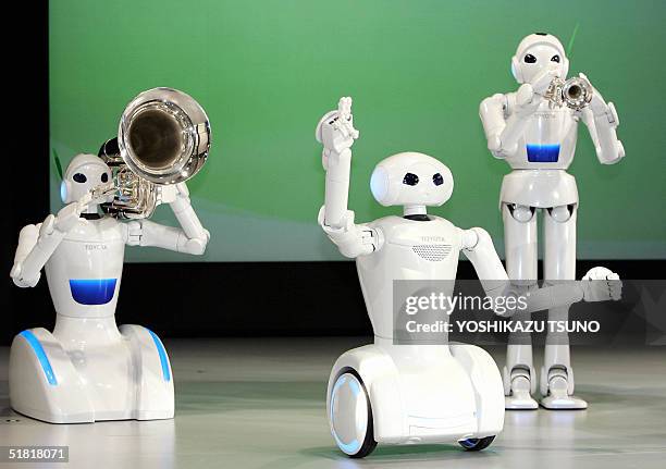 Japanese auto giant Toyota Motor's music playing robots play a trumpet , a tuba and acts as DJ at a preview for the upcoming "EXPO 2005 AICHI" at the...