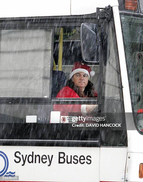 Woman bus driver wears a Santa Claus suit outside the Town Hall in Sydney, 03 December 2004. A controvesy has erupted after the Lord Mayor Clover...