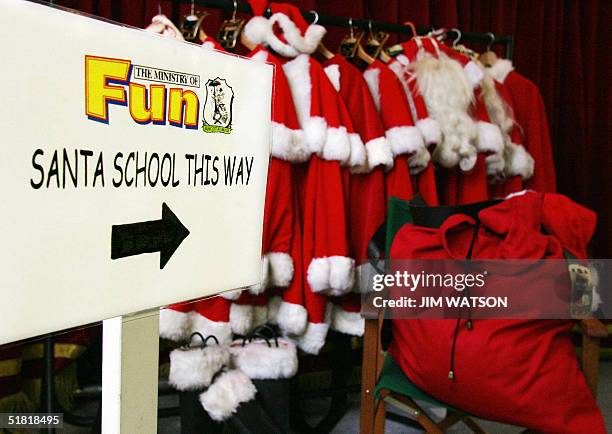 Empty Santa Claus suites sits at the Ministry of Fun 22 November 2004 in London where James Lovell says the decline for Father Christmas appearances...