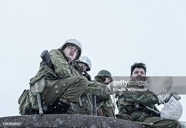 suspicious wwii us army platoon soldier tapping buddy's shoulder - platoon stock pictures, royalty-free photos & images