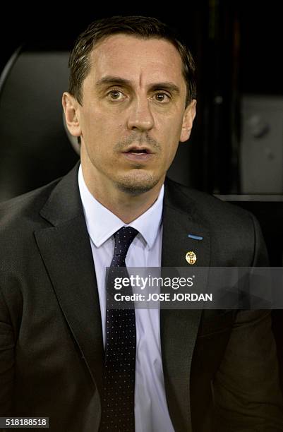 Valencia's Britihs coach Gary Neville sits on the sideline during the UEFA Champions League football match Valencia CF vs Olympique Lyonnais at the...