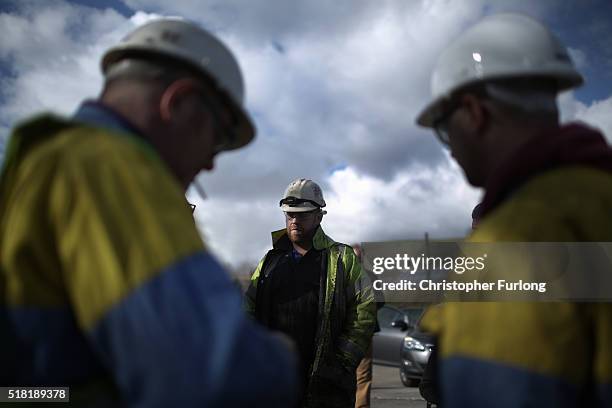 Workers from the Tata Steel plant wait for Labour leader Jeremy Corbyn to arrive and address them at the Tata Sports Club on March 30, 2016 in Port...