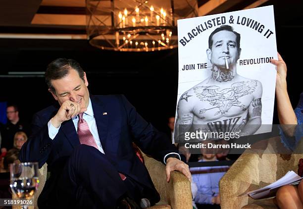 Republican Presidential candidate Senator Ted Cruz laughs at a poster while speaking to guests at a town hall event called "Women for Cruz" Coalition...