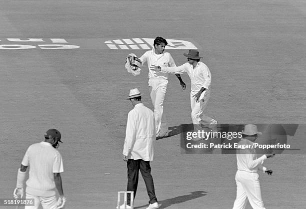 Pakistan captain Javed Miandad takes the sweater from Pakistan bowler Aqib Javed during the discussion with umpire Roy Palmer in the 3rd Test between...