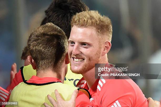 England's Ben Stokes celebrates with teammates after winning the World T20 cricket tournament semi-final match between England and New Zealand at the...