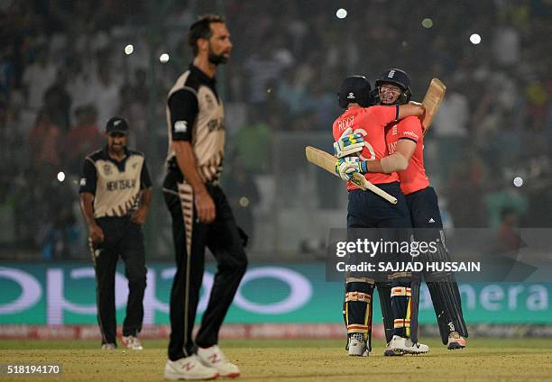 England's Joe Root and Jos Buttler celebrate after winning the World T20 cricket tournament semi-final match between England and New Zealand at the...