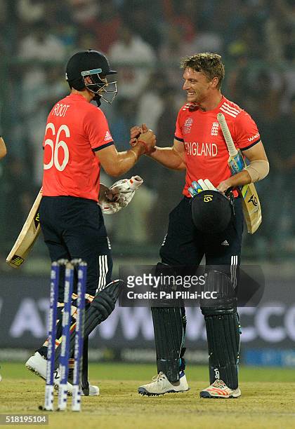 Delhi, INDIA Joe Root of England and Jos Buttler of England celebrate after winning the ICC World Twenty20 India 2016 Semi Final match between...