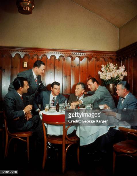American restauranteur Toots Shor talks to dinner guests at his restaurant, New York, New York, 1948. Seated from left, New York Yankees baseball...