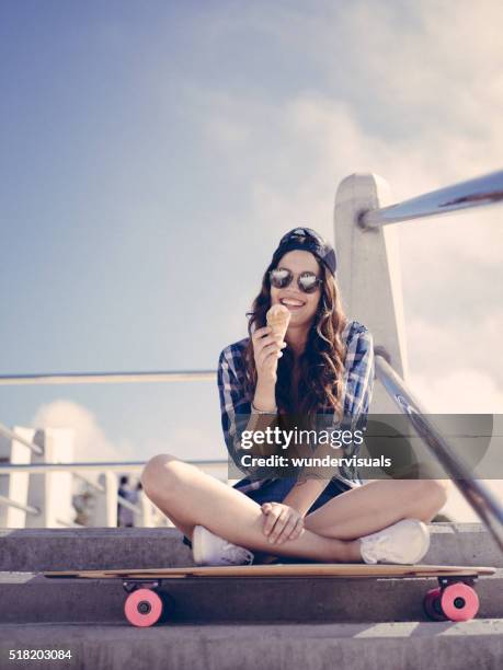 teenaged skater girl with ice cream cone on summer day - skater girl stock pictures, royalty-free photos & images