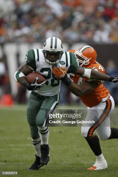 Running back Curtis Martin of the New York Jets is tackled by linebacker Andra Davis of the Cleveland Browns at Cleveland Browns Stadium on November...