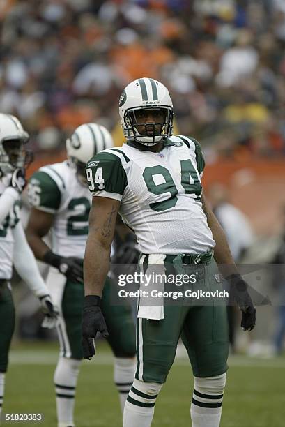 Defensive end John Abraham of the New York Jets stretches betweens plays of a game against the Cleveland Browns at Cleveland Browns Stadium on...