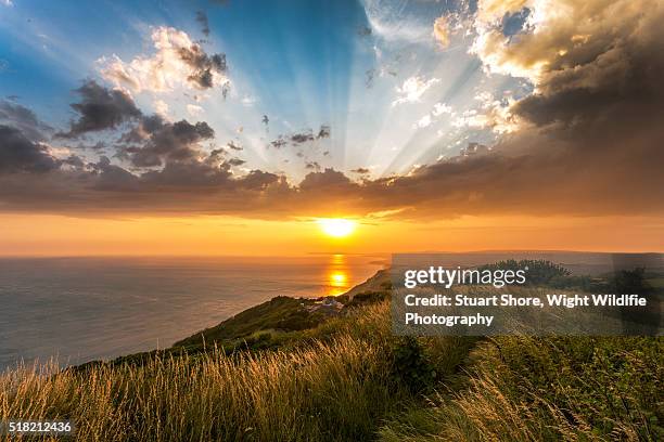 sunset over the coast - isle of wight beach stock pictures, royalty-free photos & images