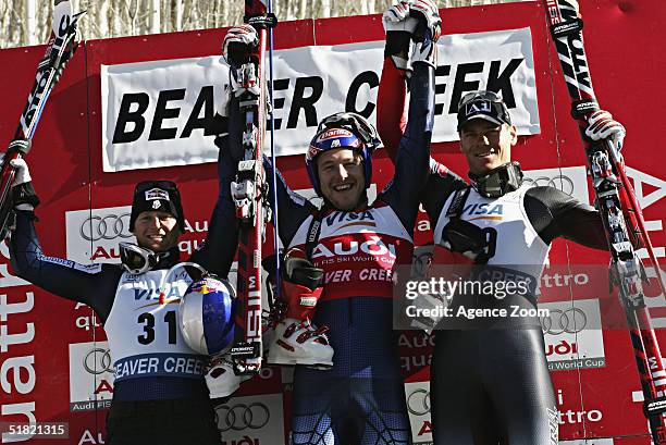 Second place Daron Rahlves of USA, 1st placed Bode Miller of USA and third place Michael Walchhofer of Switzerland celebrate on the podium after the...