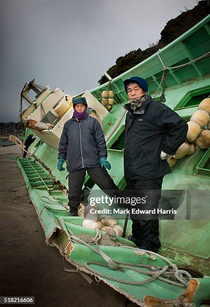The Suzuki brothers with their boat that was capsized by the March 11, 2011 tsunami in Obama Port, Fukushima Prefecture. Since they fished close to...