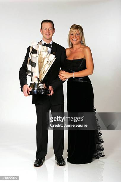 Cup Series Champion Kurt Busch and his girlfriend Eva Bryan pose with the NASCAR NEXTEL Cup trophy prior the 2004 NASCAR Nextel Cup Awards at the...