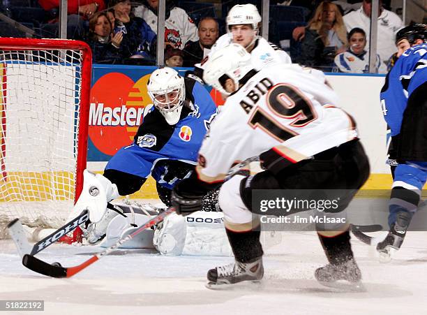 Left wing Ramzi Abid of the Wilkes-Barre/Scranton Penguins prepares to shoot the puck past goaltender Wade Dubielewicz of the Bridgeport Sound Tigers...