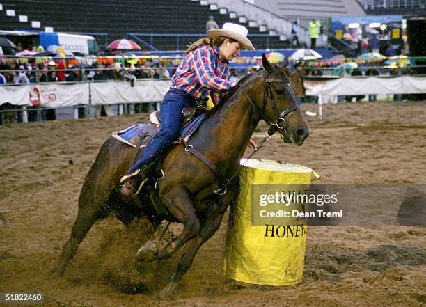 Cowgirl in action during the barrel race at the Auckland Rodeo, Carlaw Park, December 4, 2004 in Auckland, New Zealand.