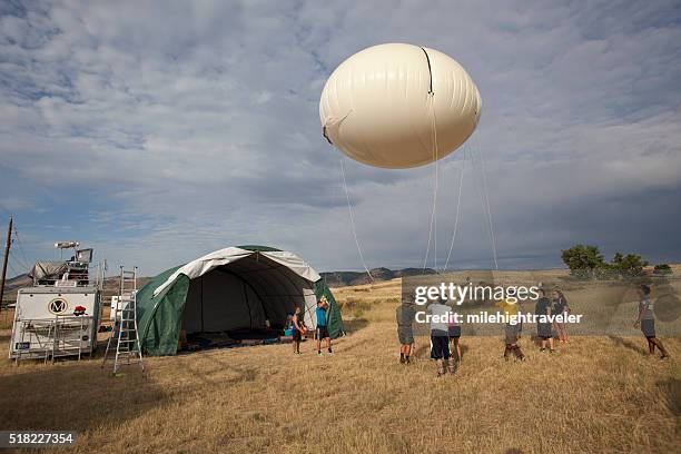 science team prepares weather balloon instruments colorado - weather balloon stock pictures, royalty-free photos & images