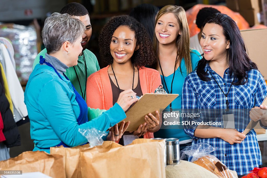 Food bank manager talks with volunteers