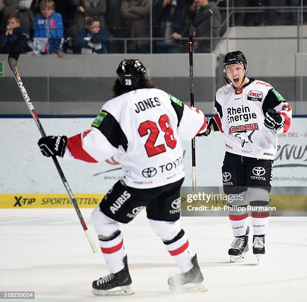 Ryan Jones and Marcel Ohmann of Koelner Haie celebrate after scoring the 0:1 during the game between the EHC Red Bull Muenchen and Koelner Haie on...