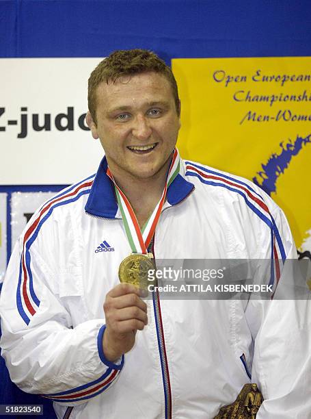 First placed French Matthieu Bataille shows his gold medal on top of the podium after winning against Georgian George Kizilashvili in the open...