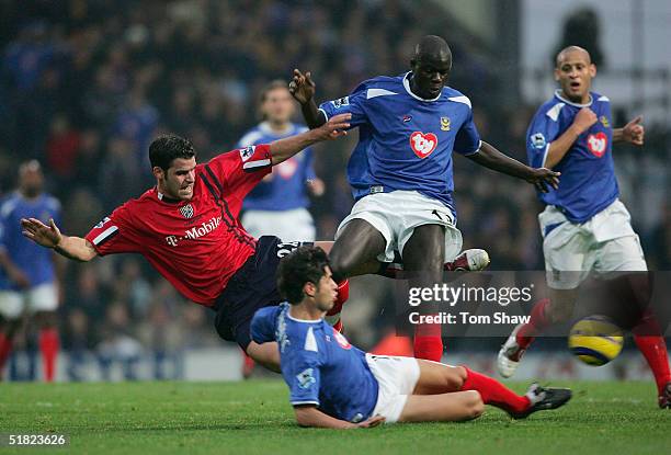 Bernt Haas of WBA is fouled by Dejan Stefanovic and Amdy Faye of Portsmouth during the Barclays Premiership match between Portsmouth and West...