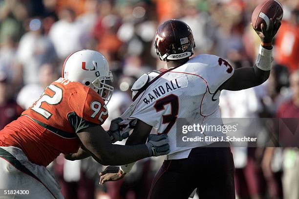 Defensive lineman Orien Harris of the University of Miami gets a hold of quarterback Bryan Randall of Virginia Tech on December 4, 2004 at the Orange...