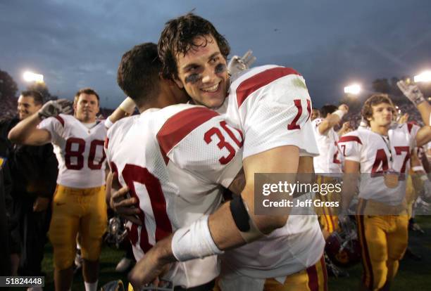 Quarterback Matt Leinart and cornerback Kevin Arbet of the USC Trojans celebrate the team's 29-24 victory over the UCLA Bruins on December 4, 2004 at...