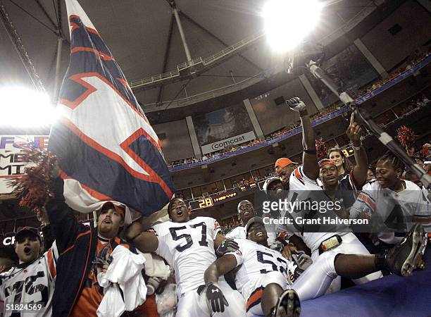 Linebackers Mayo Sowell, Kevis Burnam, and defensive end Stanley McClover of the Auburn Tigers celebrate their 38-28 victory over the Tennessee...