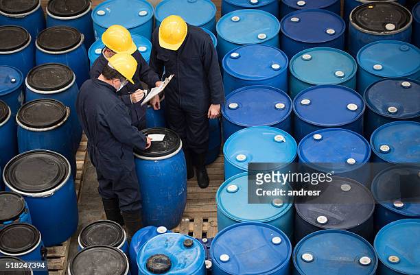 men working at a chemical warehouse - chemistry stockfoto's en -beelden