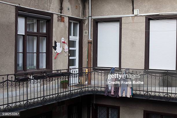 kids clothing outside at a balcony - stork stockfoto's en -beelden