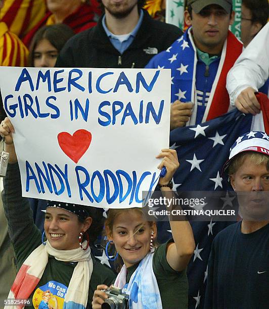 Fans hold banners cheering Andy Roddick while attending the Davis Cup final third single match facing Carlos Moya of Spain to World Number two Andy...