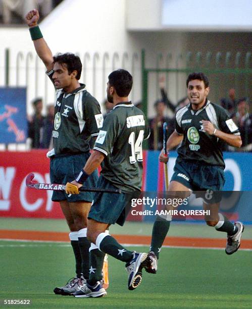 Pakistani field hockey player Sohail Abbasi celebrates scoring a goal score with teammate Shakeel Abbasi during the six-nation Champions Trophy field...