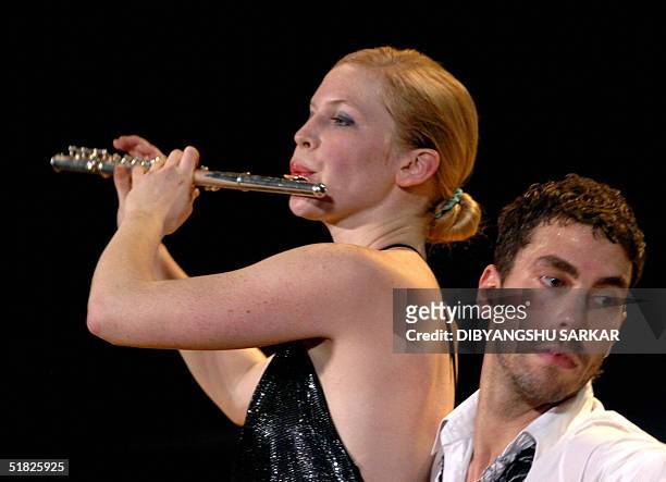 Flautist of the Berlin based German Theatre group Dorky Park performs during a production entitled 'Back to the Present' in Madras, 05 December 2004....