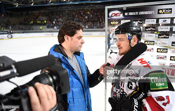 Anchorman Hans Finger with Moritz Mueller of the Koelner Haien after the game between the EHC Red Bull Muenchen and Koelner Haie on March 30, 2016 in...