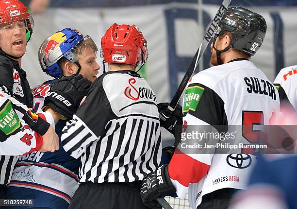 Mads Christensen of EHC Red Bull Muenchen and Alexander Sulzer of the Koelner Haien during the game between the EHC Red Bull Muenchen and Koelner...
