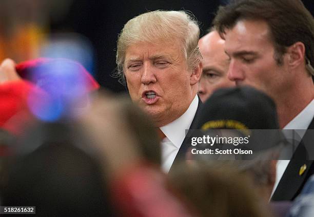 Republican presidential candidate Donald Trump greets guests following a campaign rally at the Radisson Paper Valley Hotel on March 30, 2016 in...