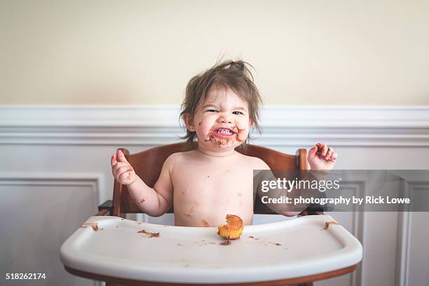 Toddler eating cupcakes