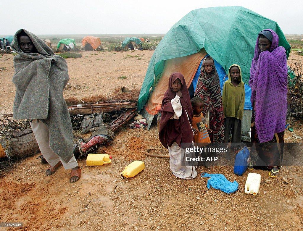 A Somali refugee family stand in the rai