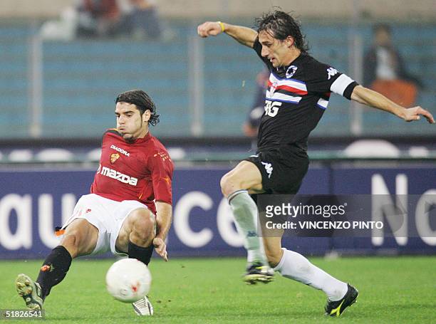 Roma's Simone Perrotta tries to tackle Sergio Volpi of Sampdoria during their Italian Serie A football match at Olympic stadium in Rome 05 December...